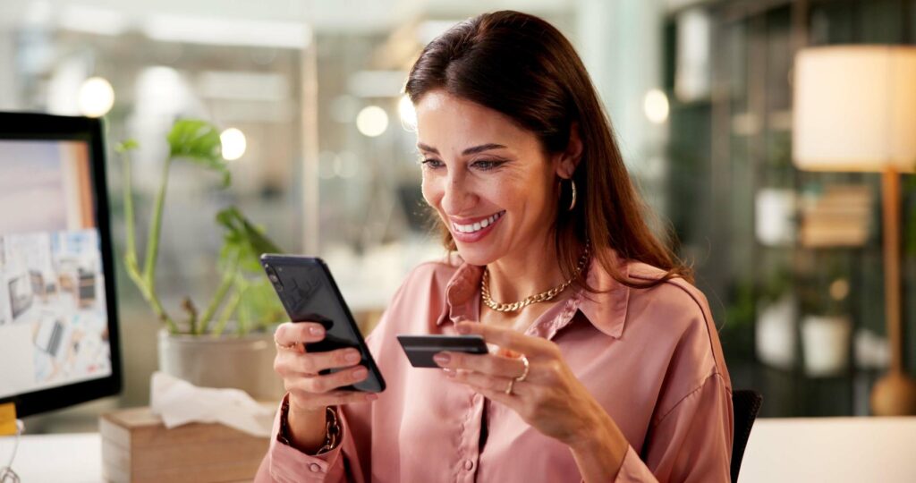 Happy woman, phone or payment with credit card for online shopping or fintech purchase at office. Female person, employee or excited shopper with mobile smartphone or debit for ecommerce at workplace