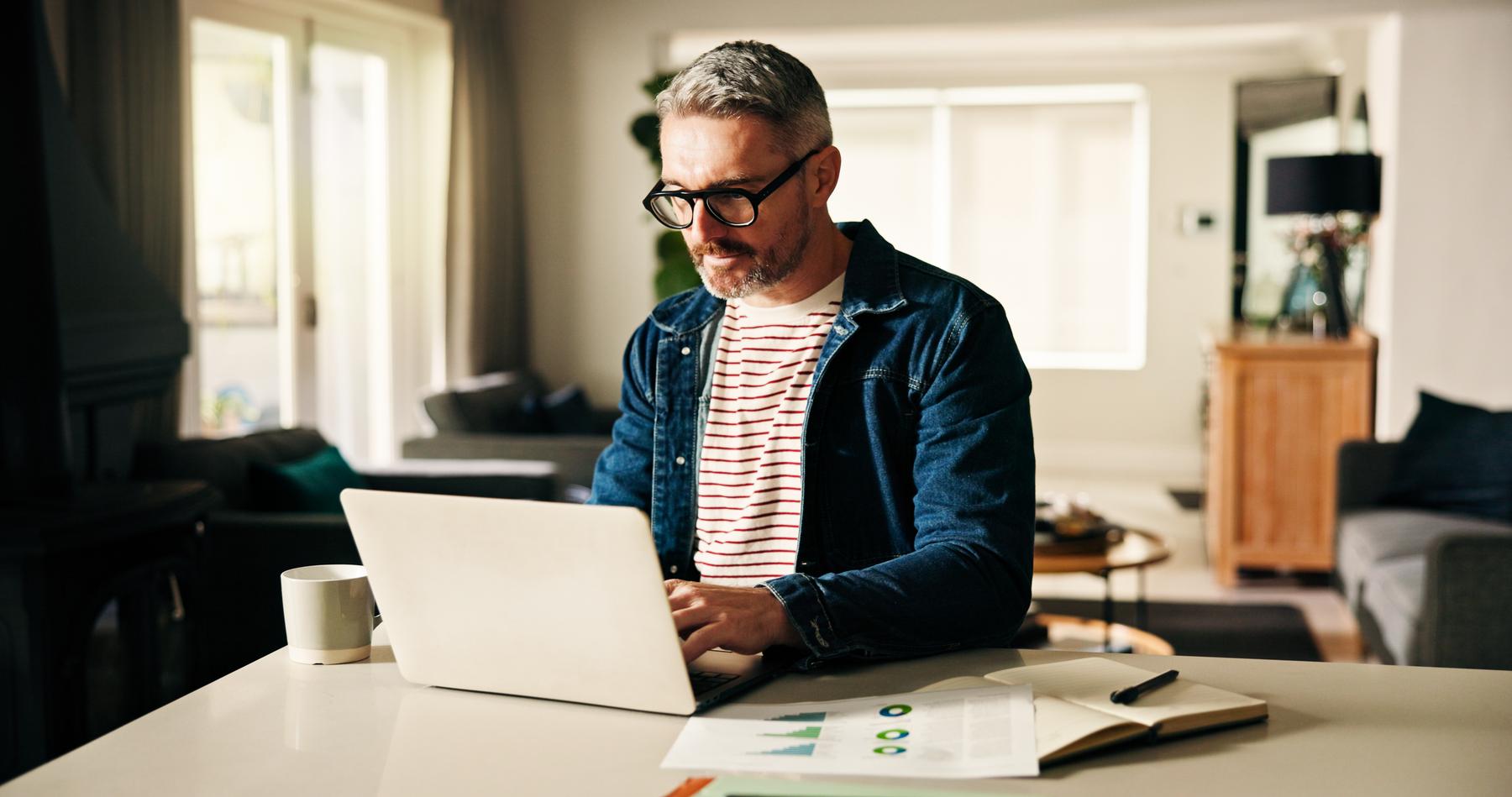 Remote work from home, laptop and man with charts, internet and risk management. Apartment, pc and mature person with profit increase, finance report and email with schedule update or budget proposal