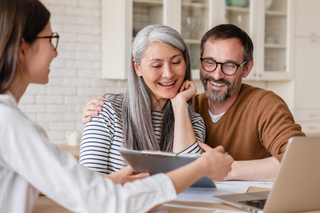 Lawyer financial advisor helping consulting showing contract mortgage loan credit business startup, signing documents by matute middle aged couple at home