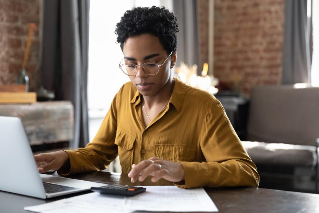 Focused millennial Black business woman calculating finance