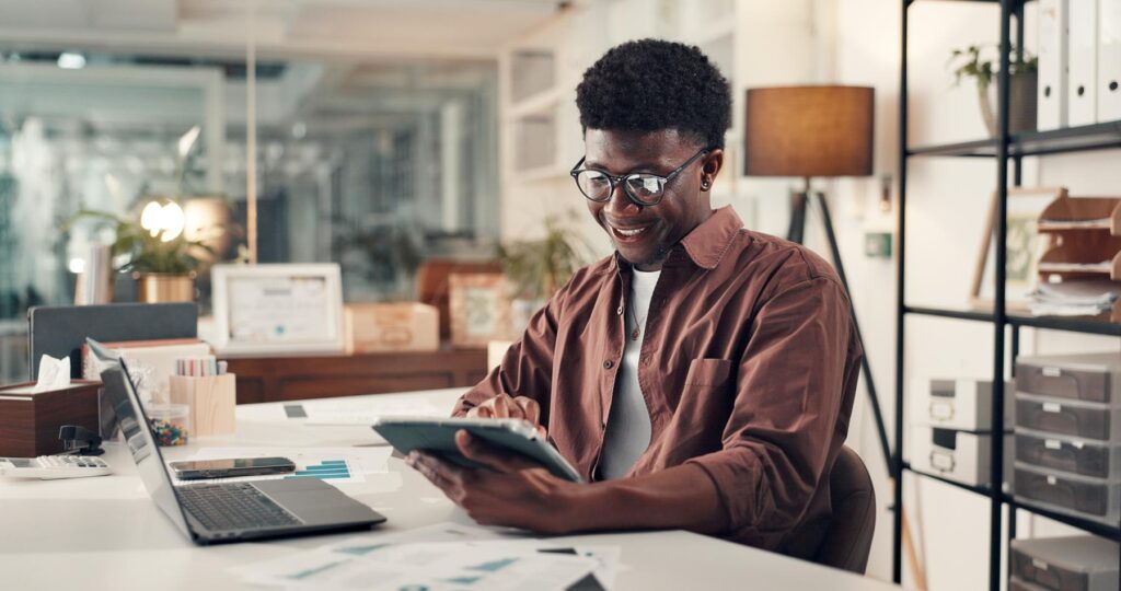 Creative, black man and reading with tablet in office for research, editor feedback and review article. Journalist, digital and proofreading story, copywriting report and information for publication