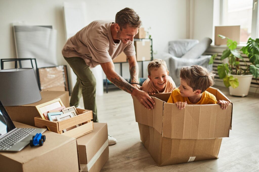 Two Boys Playing with Dad in New House