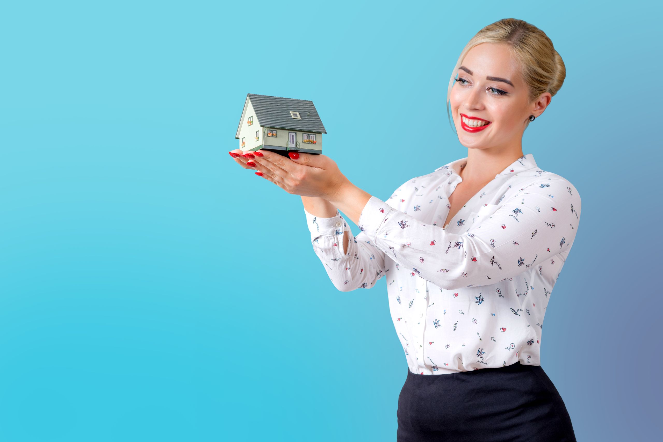 Professional property manager holding a miniature house model, symbolizing real estate and property management.