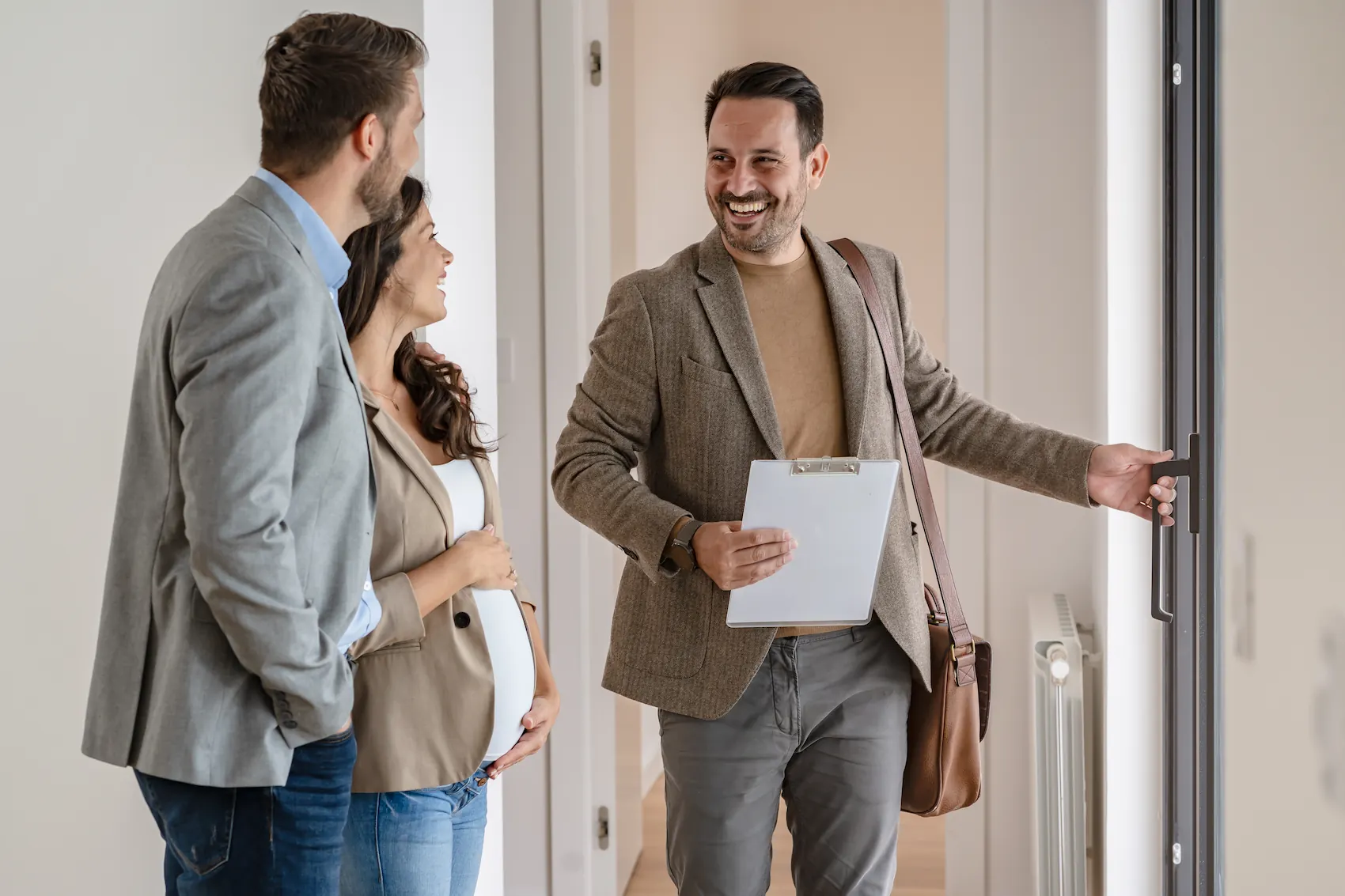A property manager in Washington opens the door for a new couple as they step inside.