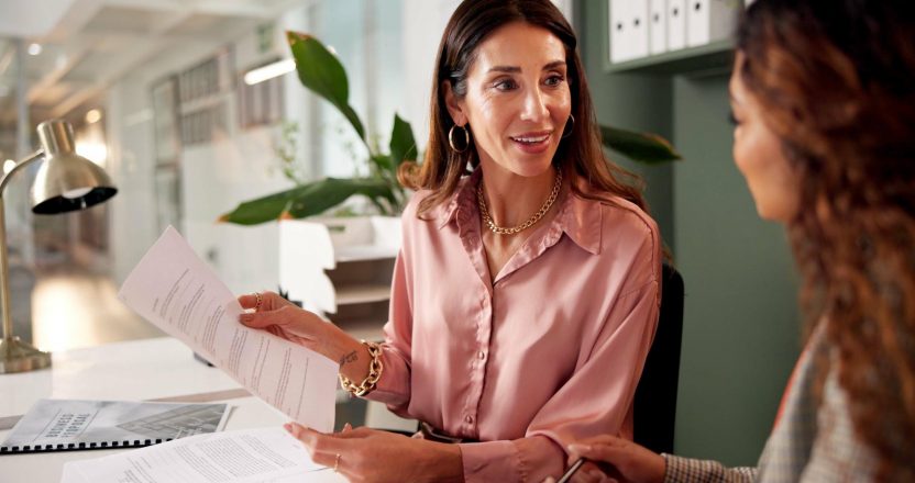 Office, meeting and financial advisor with client for paperwork, investment planning and tips. Business people, women and conversation with policy for insurance advice, guidance and corporate report