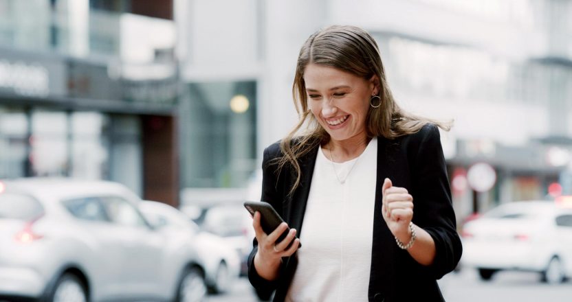 Business woman, phone and celebration in city, excited or notification for good news on commute. Person, smartphone and achievement with job promotion, goals and success with mobile app in Australia