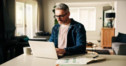 Remote work from home, laptop and man with charts, internet and risk management. Apartment, pc and mature person with profit increase, finance report and email with schedule update or budget proposal