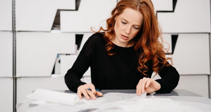 Businesswoman sorting through a pile of papers