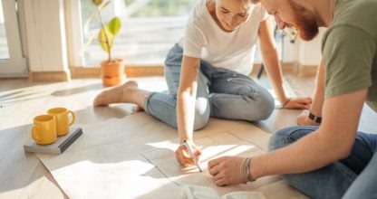 couple looking blueprints of they new house. Planning interior design