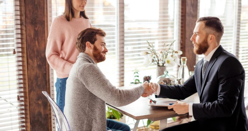 Family couple meeting with agent in office, buying, renting apartment or house.