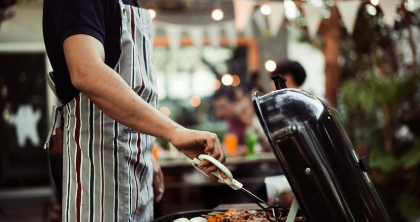 Asian man are cooking for a group of friends to eat barbecue