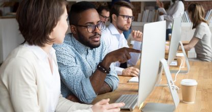 Serious african office worker explaining coworker new online project