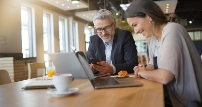 Sales business meeting between man and woman in modern office space