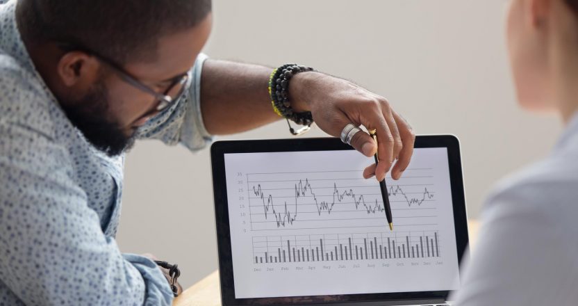 Two landlords calculating their Property Finances on a laptop to figure out their Most Profitable Rentals.