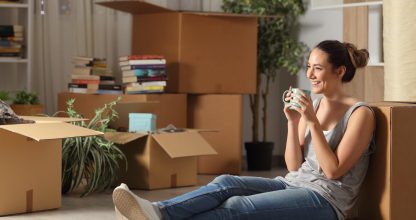 Happy tenant resting drinking coffee moving home