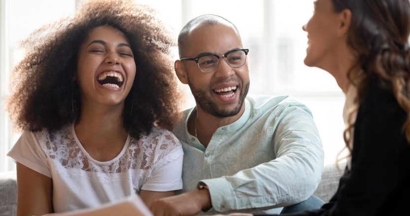 Parents and their daughter smile together after buying a profitable rental property.