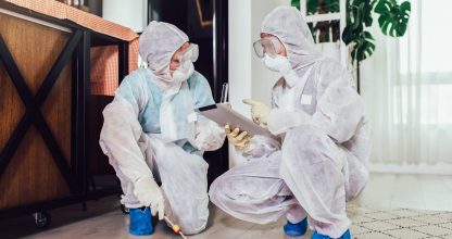 Specialists in protective suits do disinfection or pest control