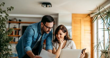 Couple doing finances at home, portrait.
