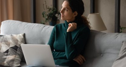 Pensive young woman work on laptop thinking