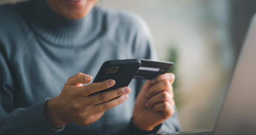 woman makes a purchase on the Internet on the smart phone with credit card, online payment, shopping online, e-commerce, internet banking, spending money