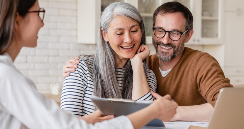 Lawyer financial advisor helping consulting showing contract mortgage loan credit business startup, signing documents by matute middle aged couple at home