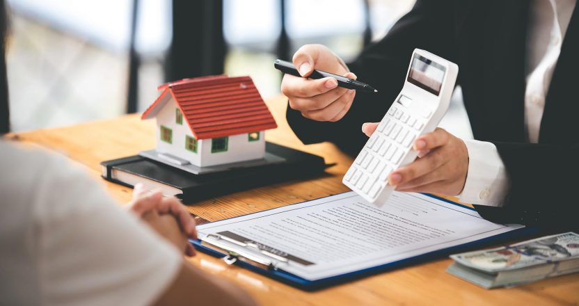 A real estate agent in a black suit discussing property taxes with a tenant.