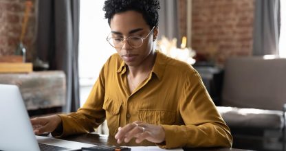 Focused millennial Black business woman calculating finance
