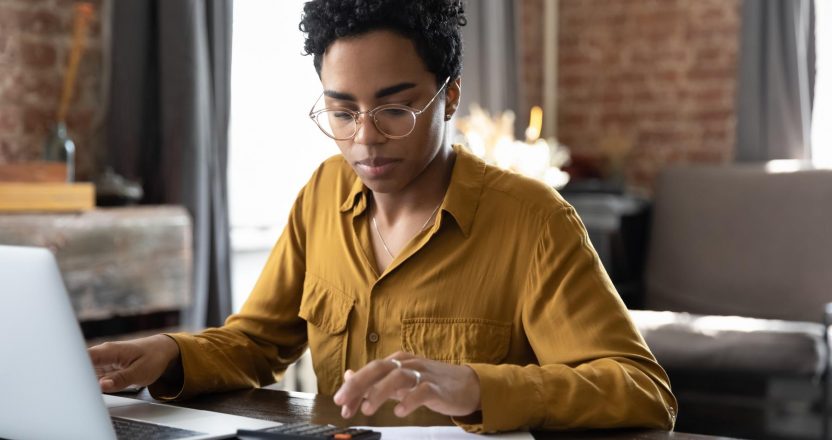 Focused millennial Black business woman calculating finance
