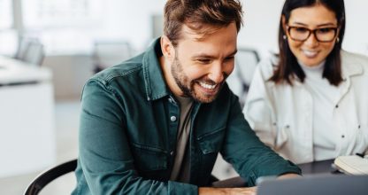 Successful business man using a laptop in a meeting with his colleague