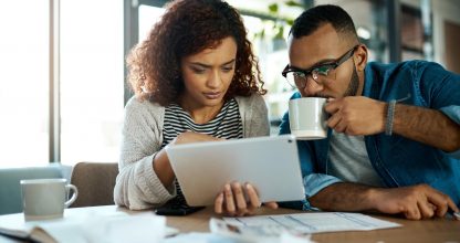Tablet, news or couple with financial budget, investment growth or planning savings online on website. Coffee, interest rates or people reading on recession for bills, inflation or household expenses