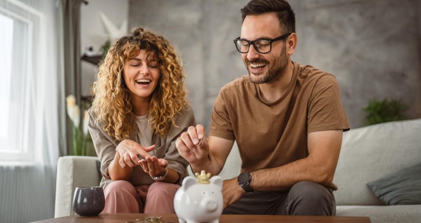 Adult couple wife and husband save money together in the piggy bank