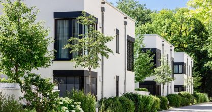 Modern Apartment Building in Green City. Low rise Residential Buildings with Modern Exterior Design White Facade, Flat roof and Landscaping. Contemporary Facade Building in Germany.