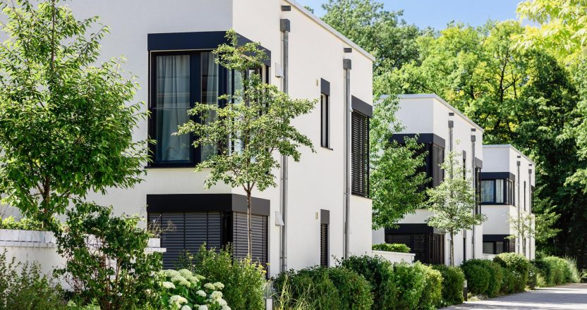 Modern Apartment Building in Green City. Low rise Residential Buildings with Modern Exterior Design White Facade, Flat roof and Landscaping. Contemporary Facade Building in Germany.