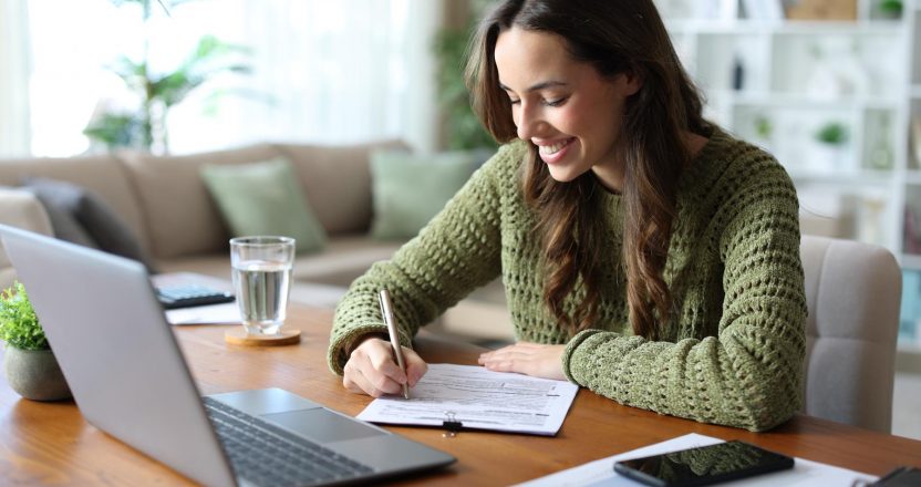 Woman signs a lease agreement she wrote as a landlord.