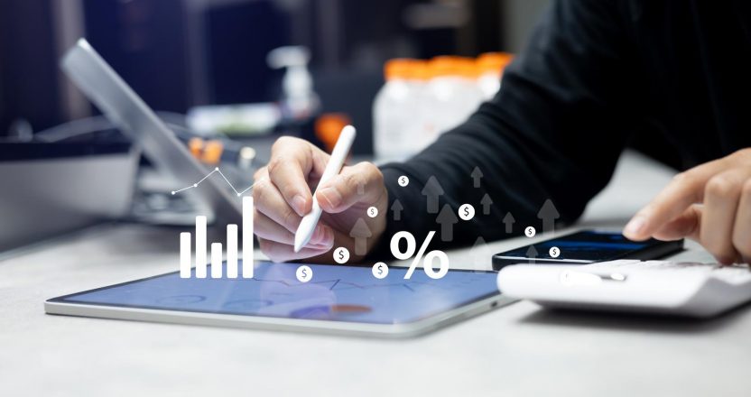 close up manager man hand write summary data by checking annual report and calculate about commission rate form company's project after complete deal in office room for business lifestyle concept